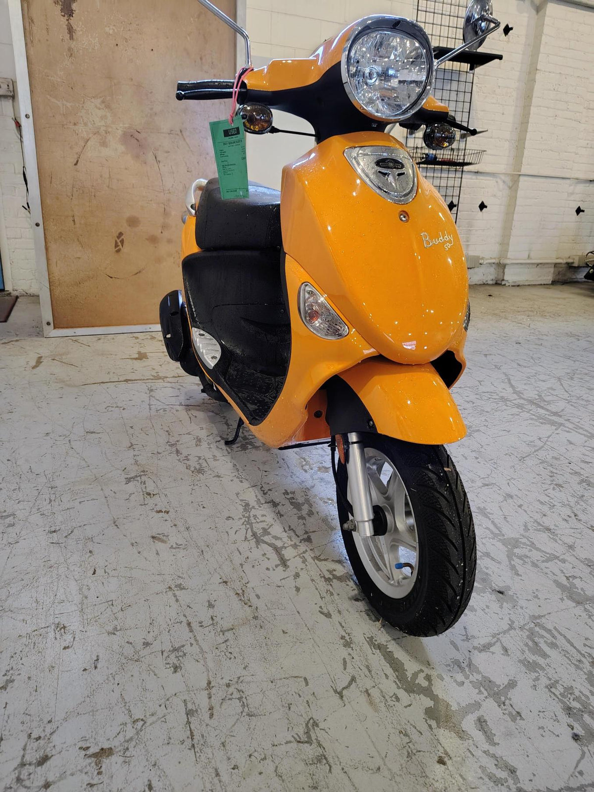 Tangerine 2021 Genuine Buddy 50 scooter, front three-quarter view