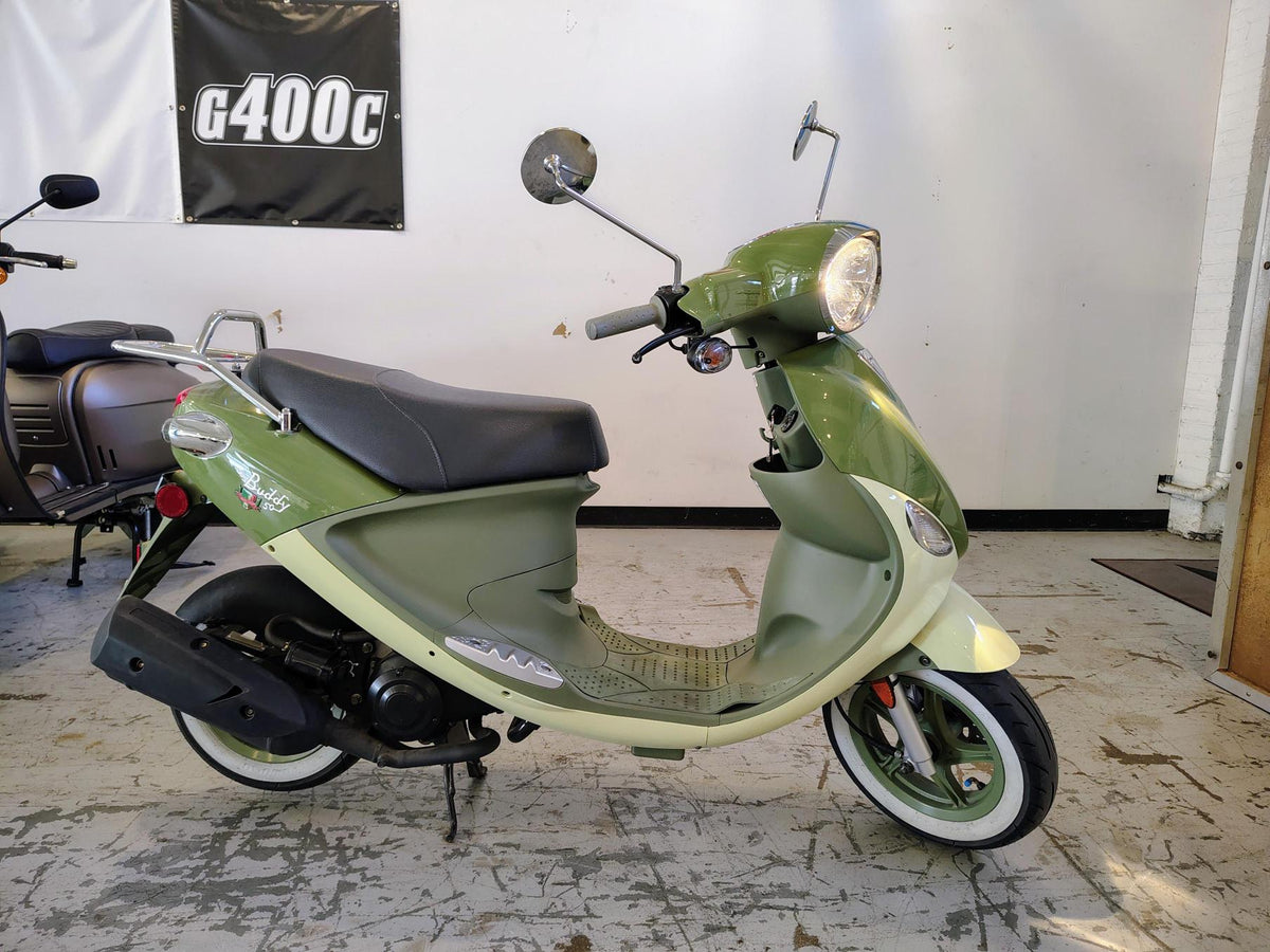 2023 Genuine Buddy 50 Italia scooter with rear rack, side view outdoors